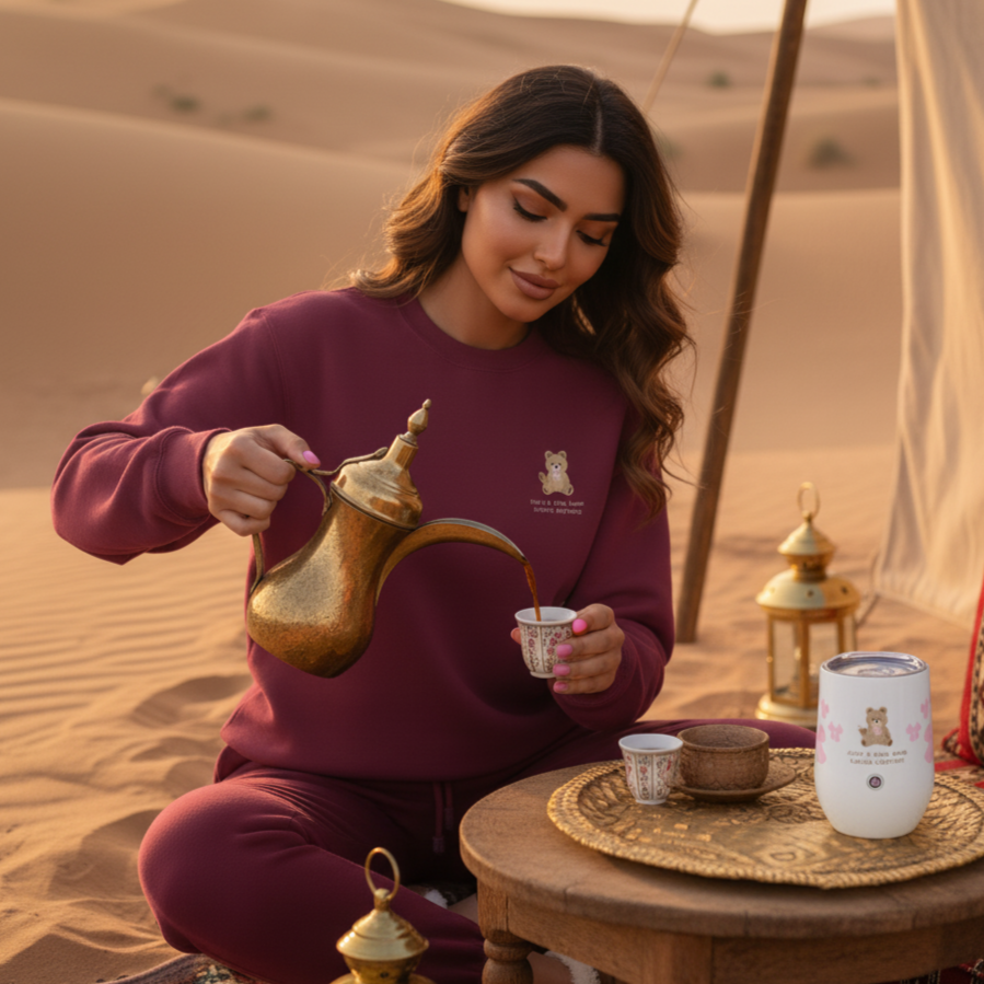 Woman in a desert setting pouring tea from a traditional teapot. sweatshirt teddy